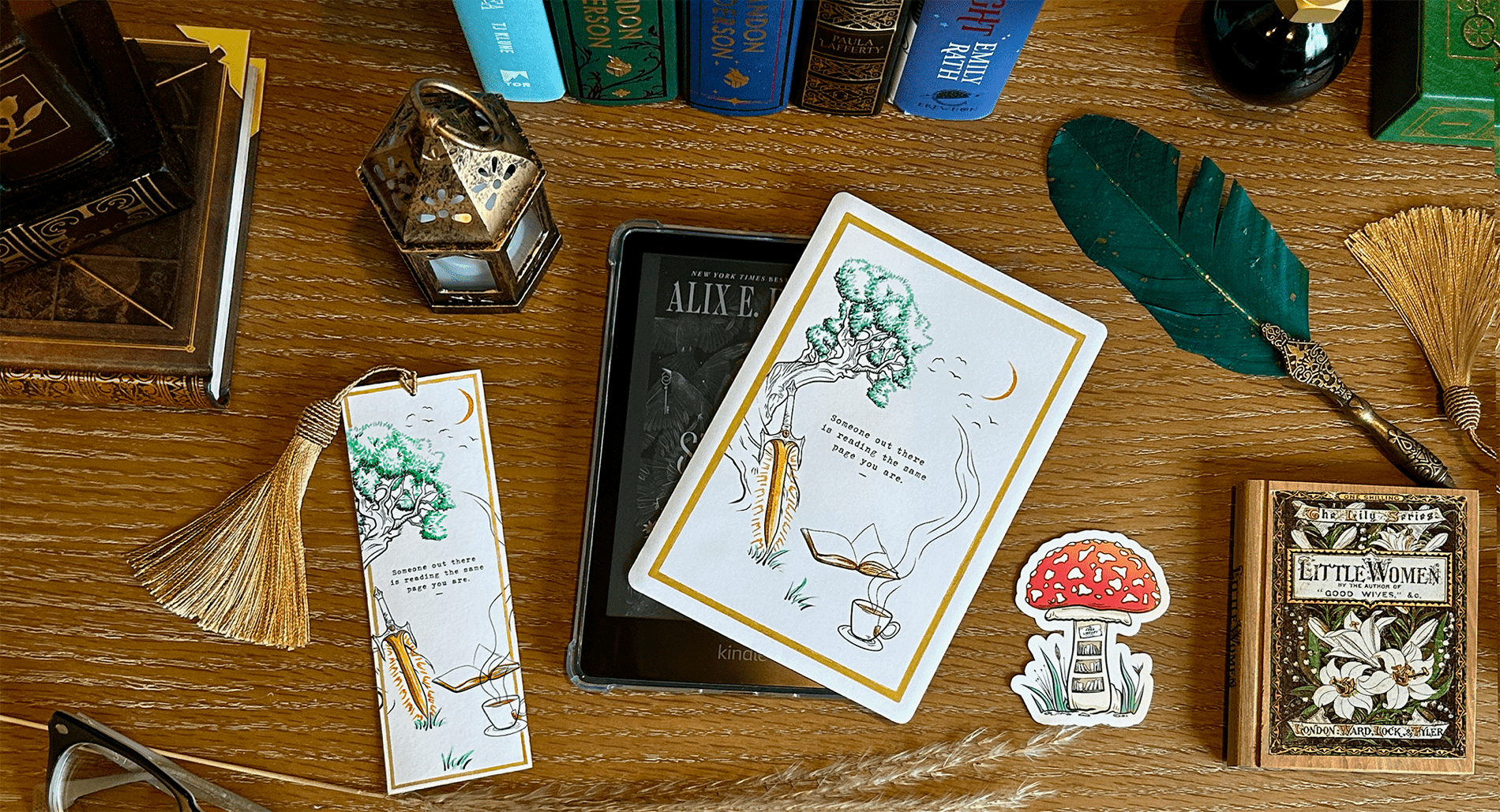 Fantasy Kindle case decor, whimsical fantasy bookmark, and a mushroom library sticker on a wooden desk surrounded by books.
