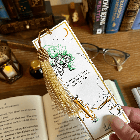 Fantasy Reading The Same Page Bookmark for readers viewed over a desk with books glasses, and a lantern.
