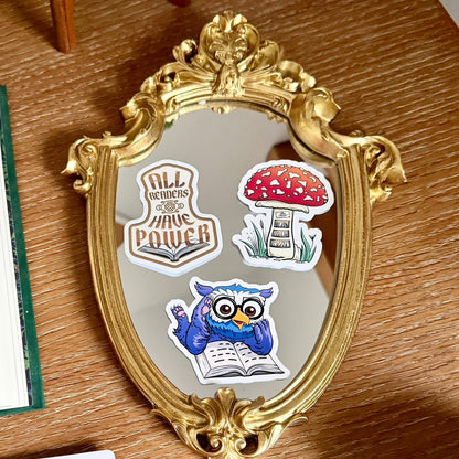 All Readers Have Power stickers, mushroom library sticker, owlbear reading sticker on a gold filigree mirror.
