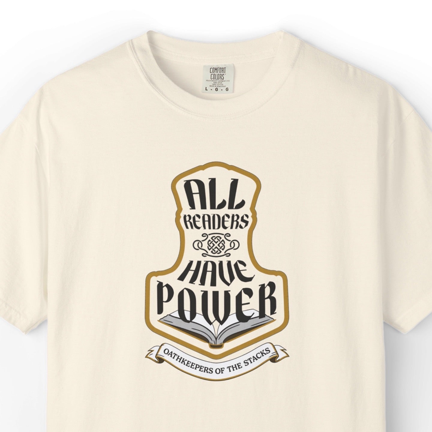 Ivory fantasy reader tee closeup with All Readers Have Power hammer emblem on the chest.