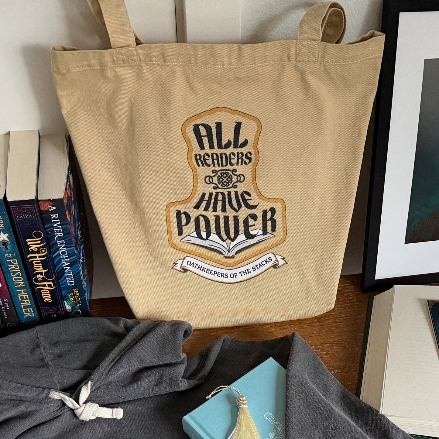 All Readers Have Power fantasy book tote standing on a desk, filled with fantasy novels.