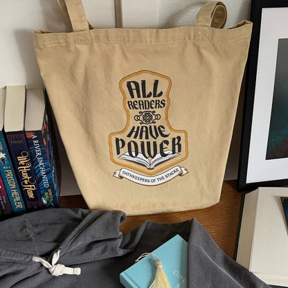 All Readers Have Power fantasy book tote standing on a desk, filled with fantasy novels.