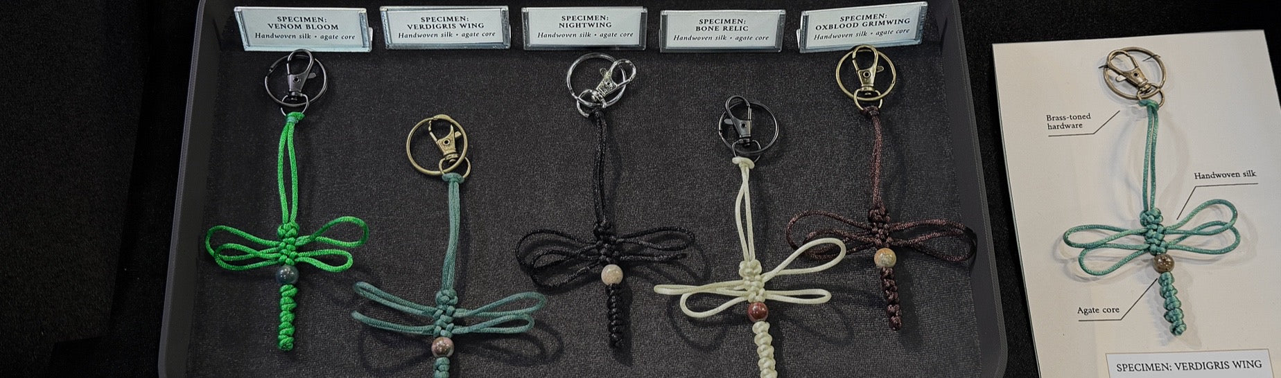 Labeled and catalogued dragonfly specimen keychains handmade with silk cord, a genuine agate bead, and durable keyrings.