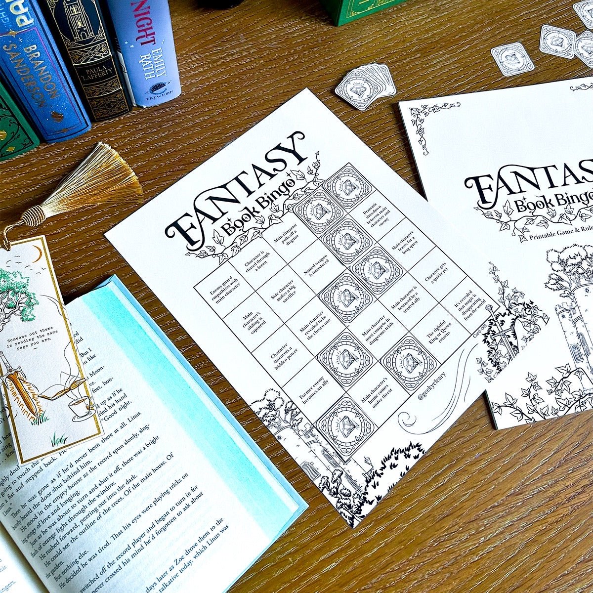 Fantasy book bingo sheets on a wooden table with game cards, gem pieces, and books.