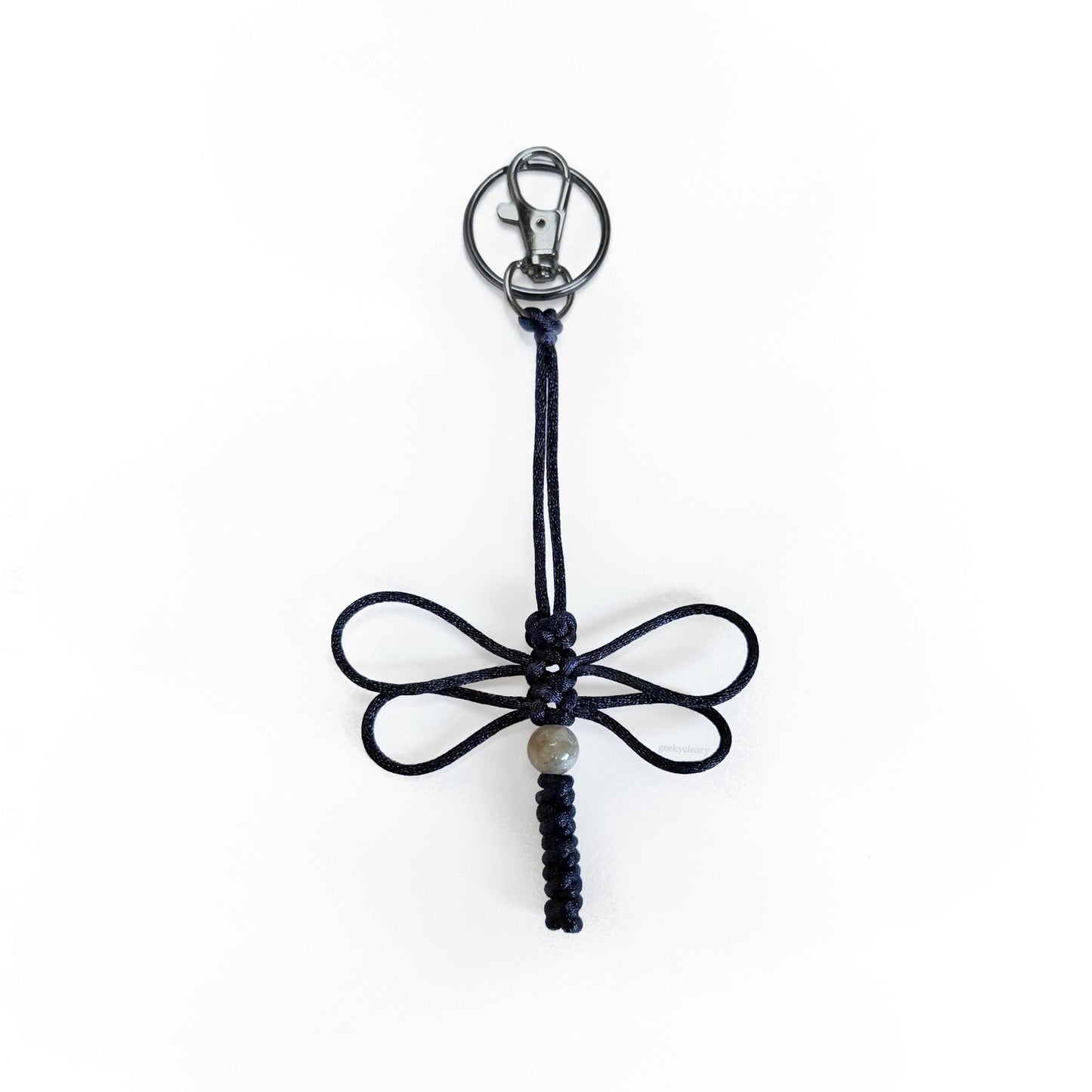 Black-colored dragonfly keychain handwoven with silk cord and a real agate bead. Durable silver colored clip and keyring.