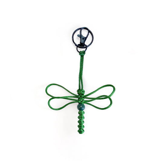 Green-colored dragonfly keychain handwoven with silk cord and a real agate bead. Durable black colored clip and keyring.