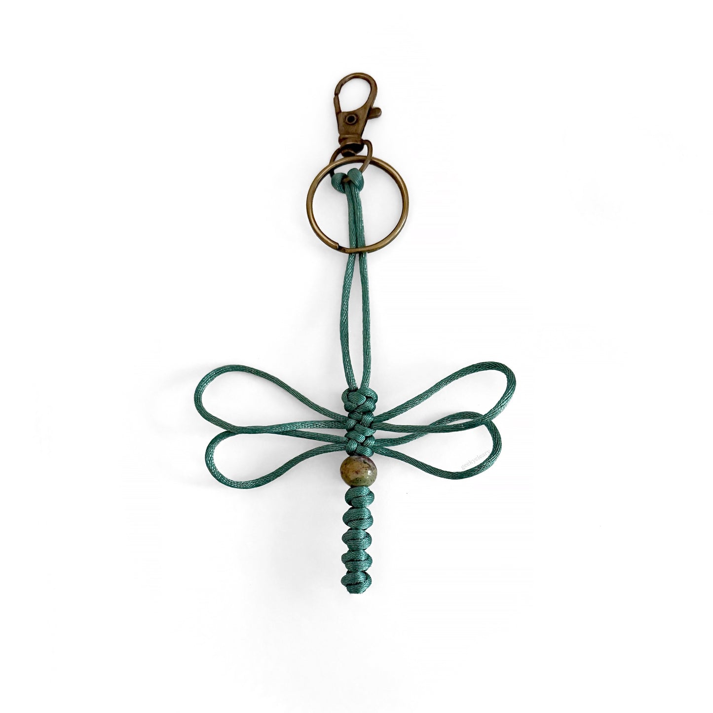 Teal-colored dragonfly keychain handwoven with silk cord and real agate bead. Durable brass colored clip and keyring.