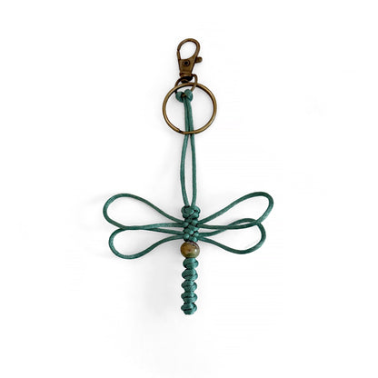 Teal-colored dragonfly keychain handwoven with silk cord and real agate bead. Durable brass colored clip and keyring.